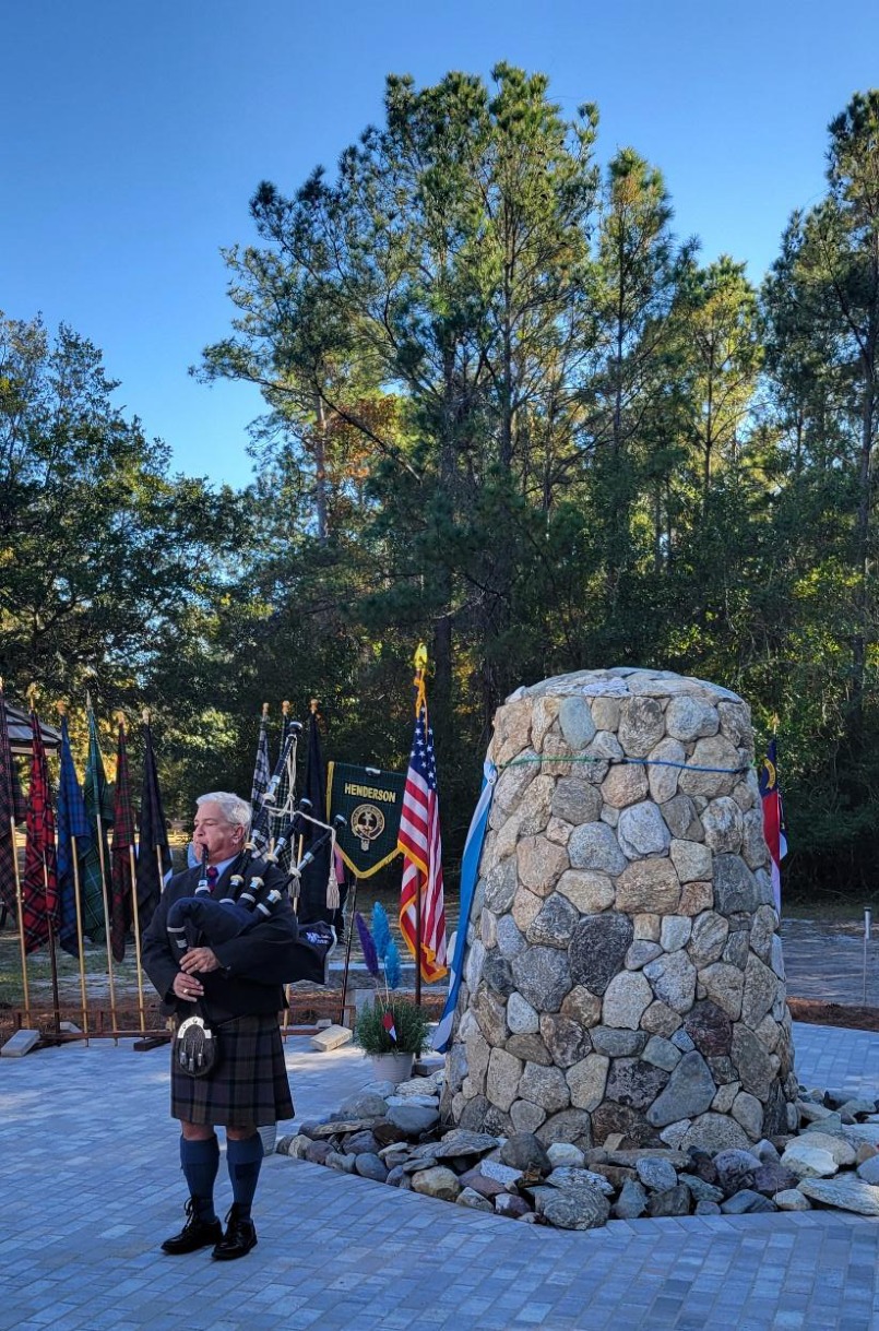 Bill Caudill, piper at memorial cairn